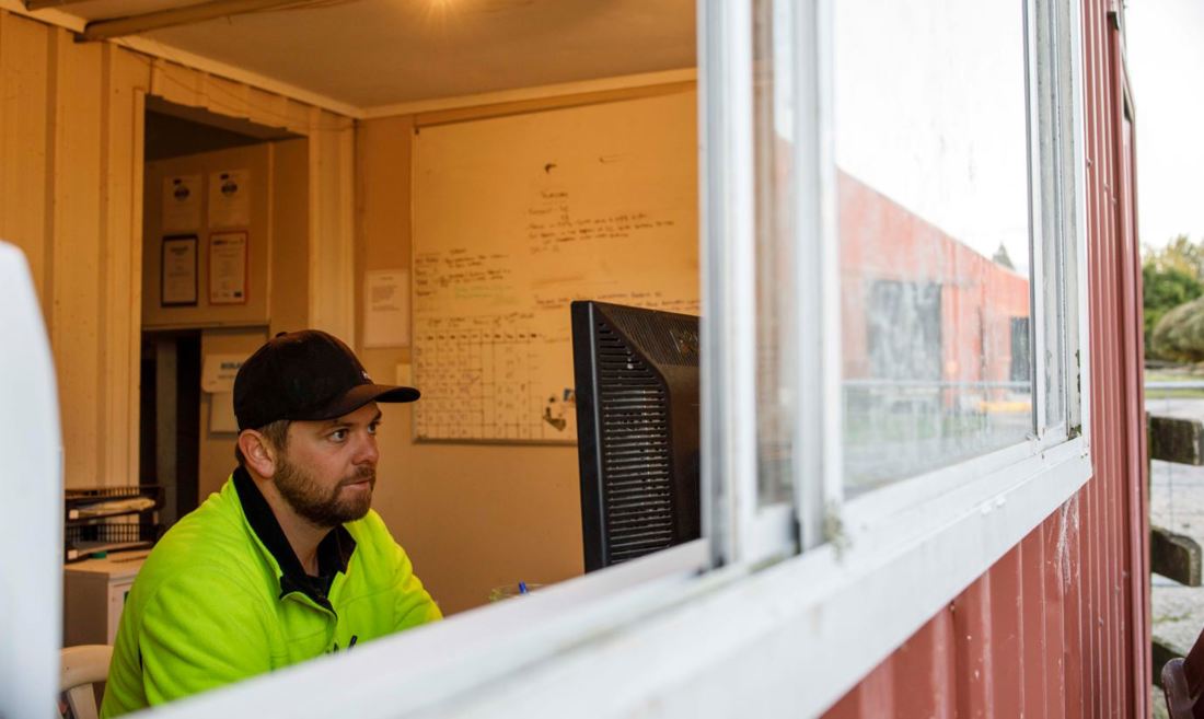 Reece Cox, a New Zealand dairy farmer, working on his farm budgets at a computer